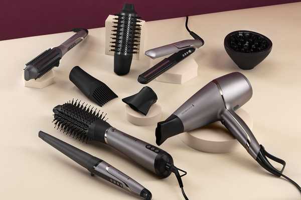 PROluxe You range comprising of hair dryer, hair straightener, hot brush, air styler, and curler placed on a cream countertop on pedestals.
